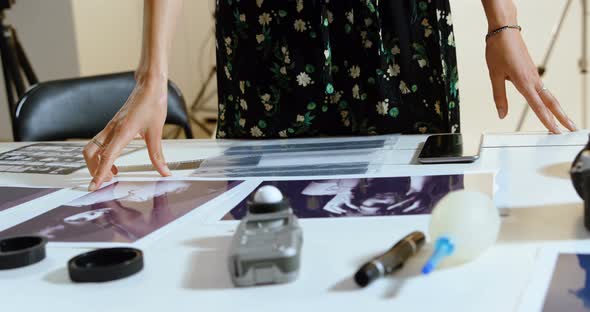 Female photographer standing at desk 