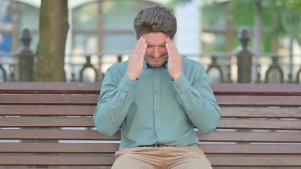 Upset Middle Aged Man Worried While Sitting,, Outdoor