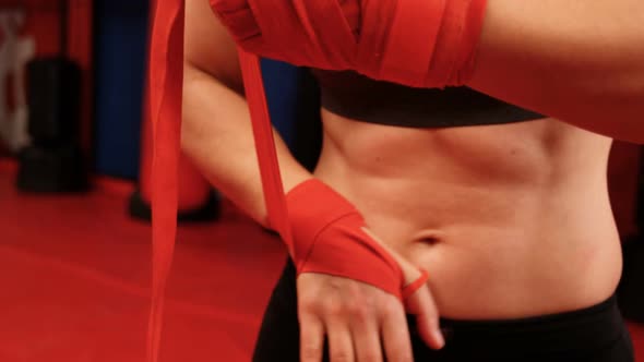 Female boxer wearing red strap on wrist