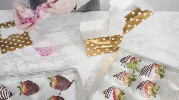 Step by step. Packaging chocolate dipped strawberries into a paper box for a gift.