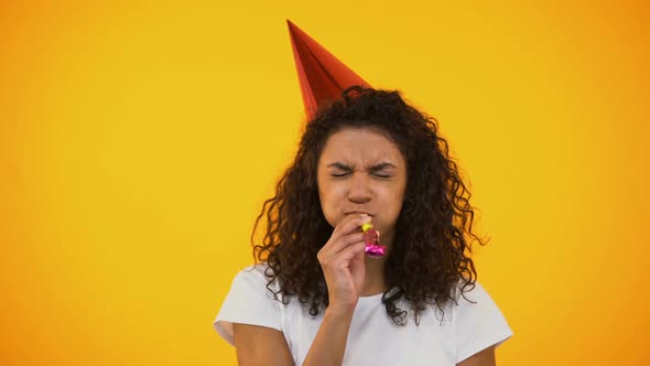 Funny Biracial Woman Blowing Party Horn With Effort Celebrating Birthday Holiday