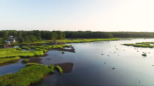 Rising shot of drone flying over Calabash River near downtown Calabash NC at sunrise