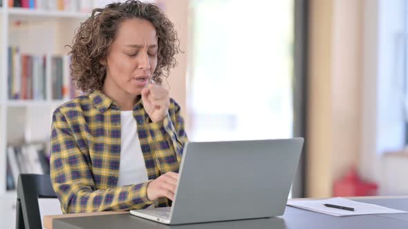 Young Mixed Race Woman with Laptop at Work Coughing