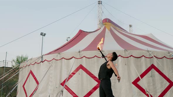 Circus artist performing fire breathing trick