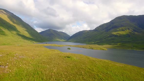 Beautiful mountain range with grassland and lake 4k