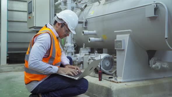 An engineer man or worker, people using a laptop computer, working in industry factory.