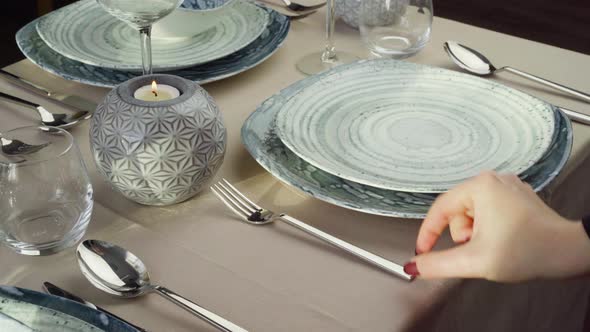 Close Up of Woman Setting Table