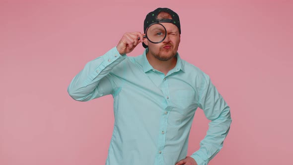 Investigator Researcher Man with Magnifying Glass Near Face Looking Into Camera with Big Zoom Eye