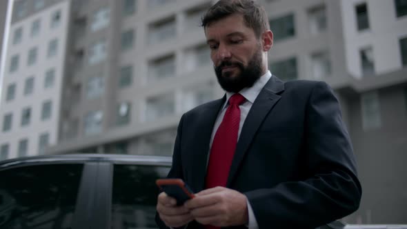 Business Man Texting Phone in the Street