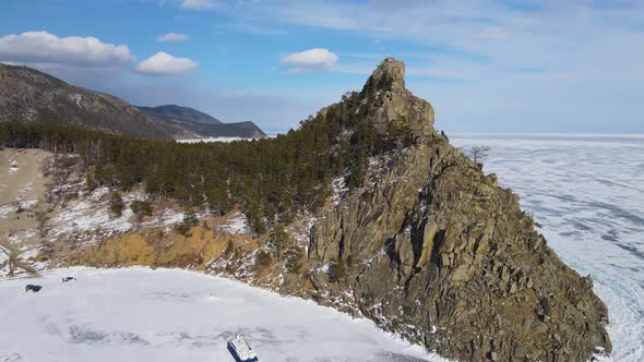 A rock on the shore of Baikal. A popular tourist spot. Lake on frosty sunny day