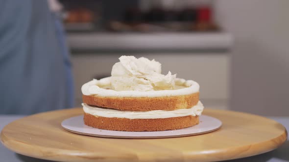 Applying the Cream to the Sponge Cake During the Assembly of the Cake