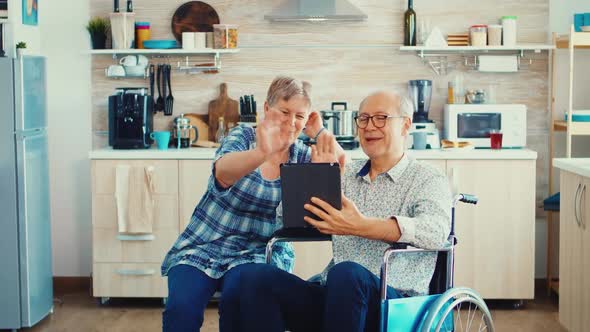 Senior Couple on Video Call with Grandchildrens