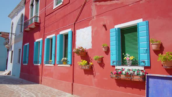 Bright House with Shutters and Flowerpots on Window Sills