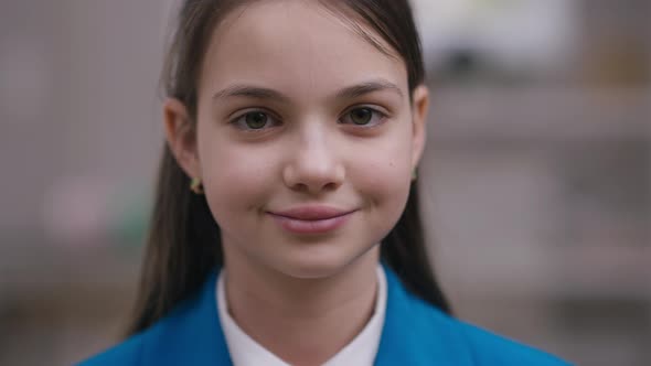 Closeup Portrait of Beautiful Caucasian Brunette Girl Looking at Camera Smiling