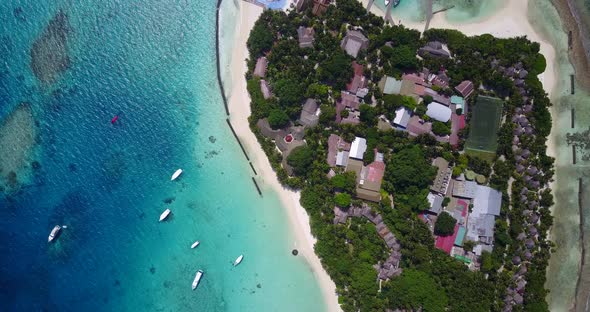 Beautiful above abstract shot of a white sand paradise beach and blue water background 