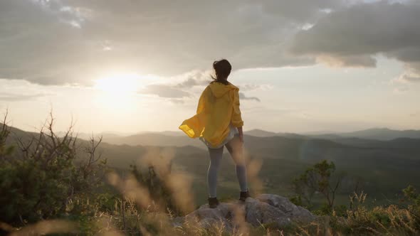 The Girl Runs to the Top of the Mountain and Feels Freedom