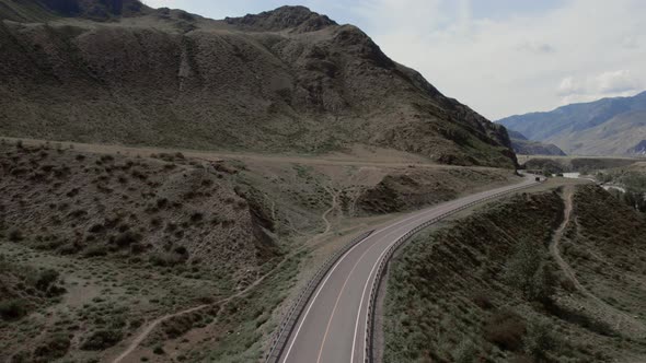 Mountains valley of Altai with traffic cars on Chuya highway and Katun river