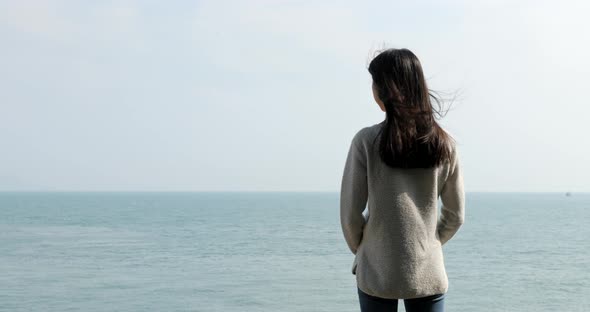 Young woman looking at the sea