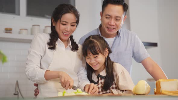 Family relationship, Asian happy family making food preparation in kitchen room together at house.