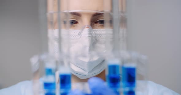 Doctor Carefully Drips Medicine From Pipette Into Sample Glass Tubes for DNA Analysis at Laboratory alt
