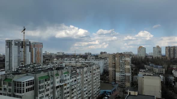 Aerial View Time Lapse of Building Roofs and Clouds Fast Moving By Wind