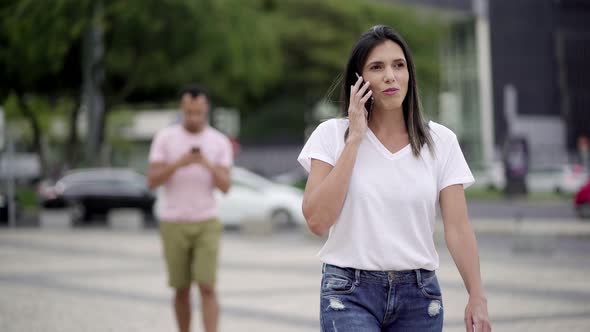 Relaxed Young Woman Talking on Smartphone