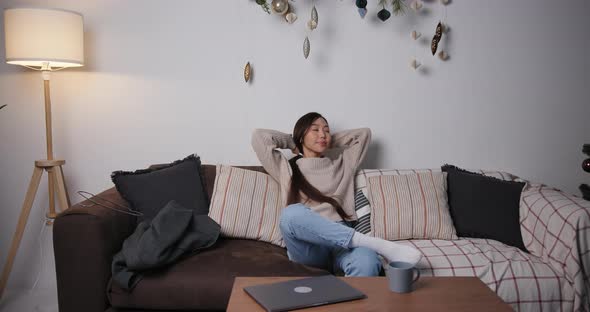 Asian Business Woman Sitting at Home and Dreaming in the Evening on Holidays