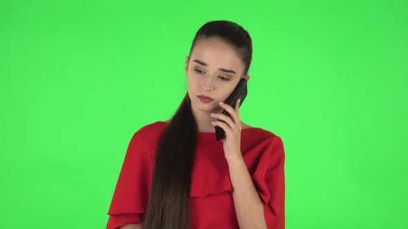 Portrait of Pretty Young Woman Is Talking for Mobile Phone. Green Screen