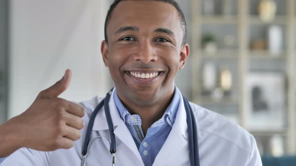 Thumbs Up by Smiling Confident African-American Doctor
