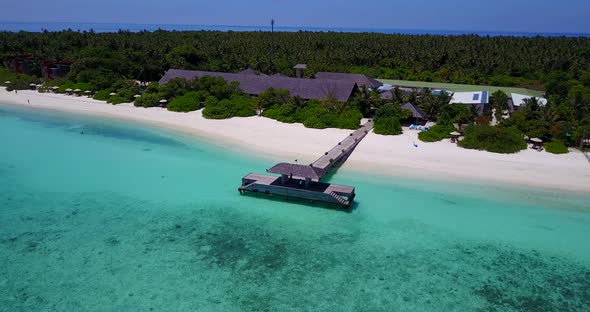 Tropical drone travel shot of a white sand paradise beach and blue sea background 