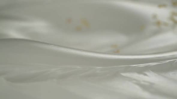 Fresh lemon slices and lemon peels rain on yogurt in slow motion – Close up