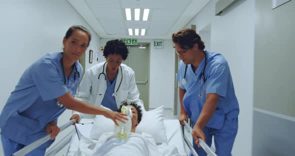 medical team pushing emergency stretcher bed in the corridor at hospital