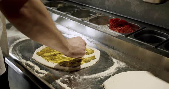 The chef prepares fresh pizza in the restaurant kitchen. Italian pizza.