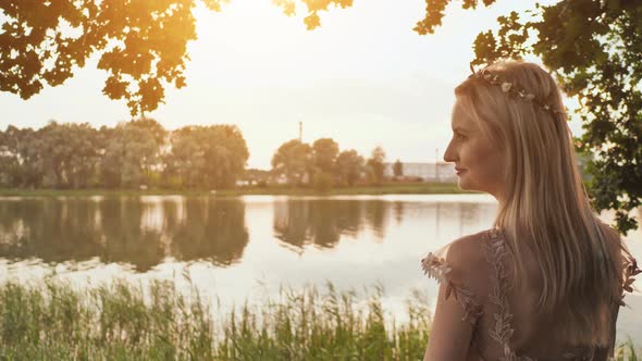 Beautiful Young Blond Woman Outdoors Portrait Near the Lake