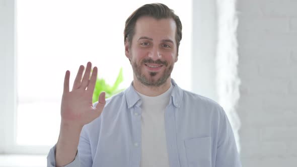 Portrait of Young Man Waving Welcoming