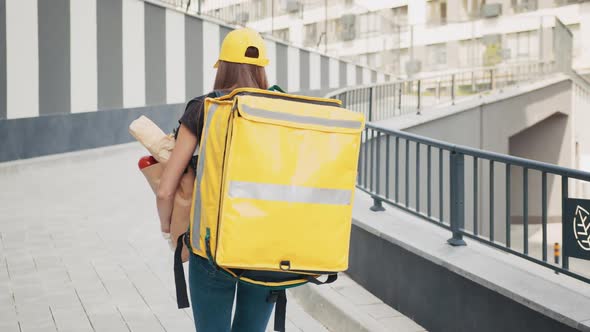 Beautiful Young Caucasian Woman in Yellow Hat and Tshirt Walking the Street on