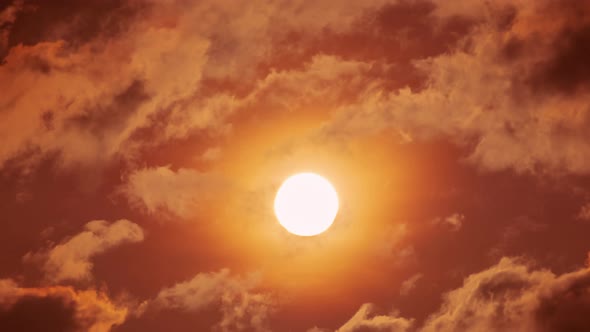 Time lapse of dramatic sunset with orange sky