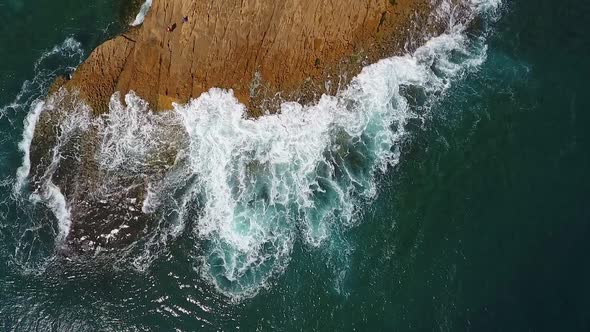 Nostalgic Aerial Video in Slow Motion of the Sea the Waves Smoothly Roll on the Rocky Shores of the