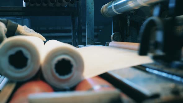 Paper Roll Making Machine Operated By a Factory Worker