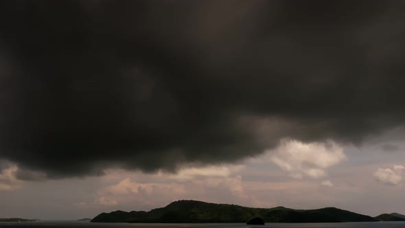 Building motions storm clouds.Dark clouds sky time lapse. Raining storm clouds over sea. Cloudscape