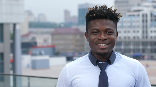 Portrait of Smiling Businessman Standing Outdoors