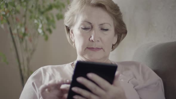 Mature woman using her tablet