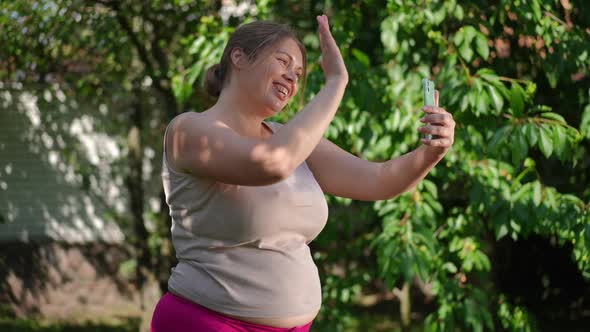 Side View Joyful Plussize Woman Waving at Smartphone Video Chat Talking in Slow Motion