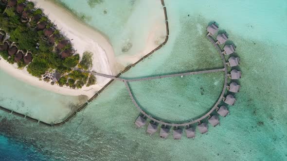 Aerial view of footbridge connecting bungalows, Maldives island.