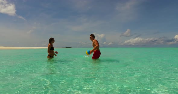 Young boy and girl married on vacation live the dream on beach on summer white sandy 4K background