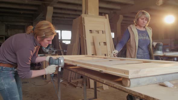 Woman sanding in a carpentry workshop