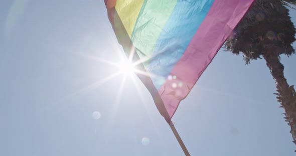 Pride LGBT rainbow flag waving in slow motion during a pride parade