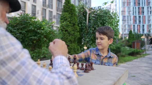 LIttle Genius Cute Boy Child Making Chess Move