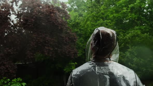 Rain.Shower.man in the rain. Slow motion. Raindrops on a raincoat . 