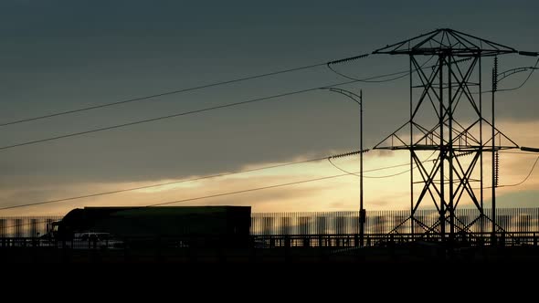 Vehicles Passing On Highway At Sunset alt